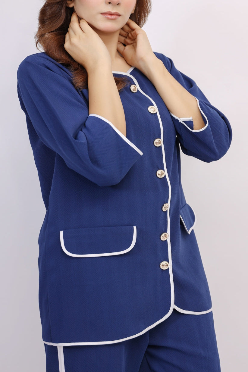 Blue pajama set with white trim worn by a person on a light gray background