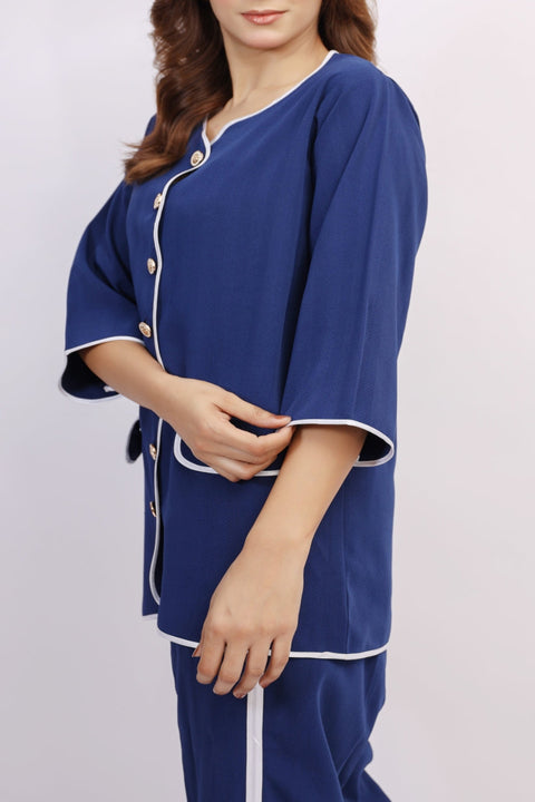 Woman wearing a blue pajama set with white trim on a light gray background — Ecko Apparel