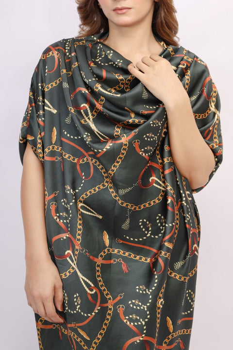 Woman wearing a dark green scarf with chain pattern on a plain background — alternate view