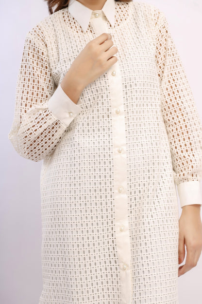Long beige textured shirt with white buttons on a plain background