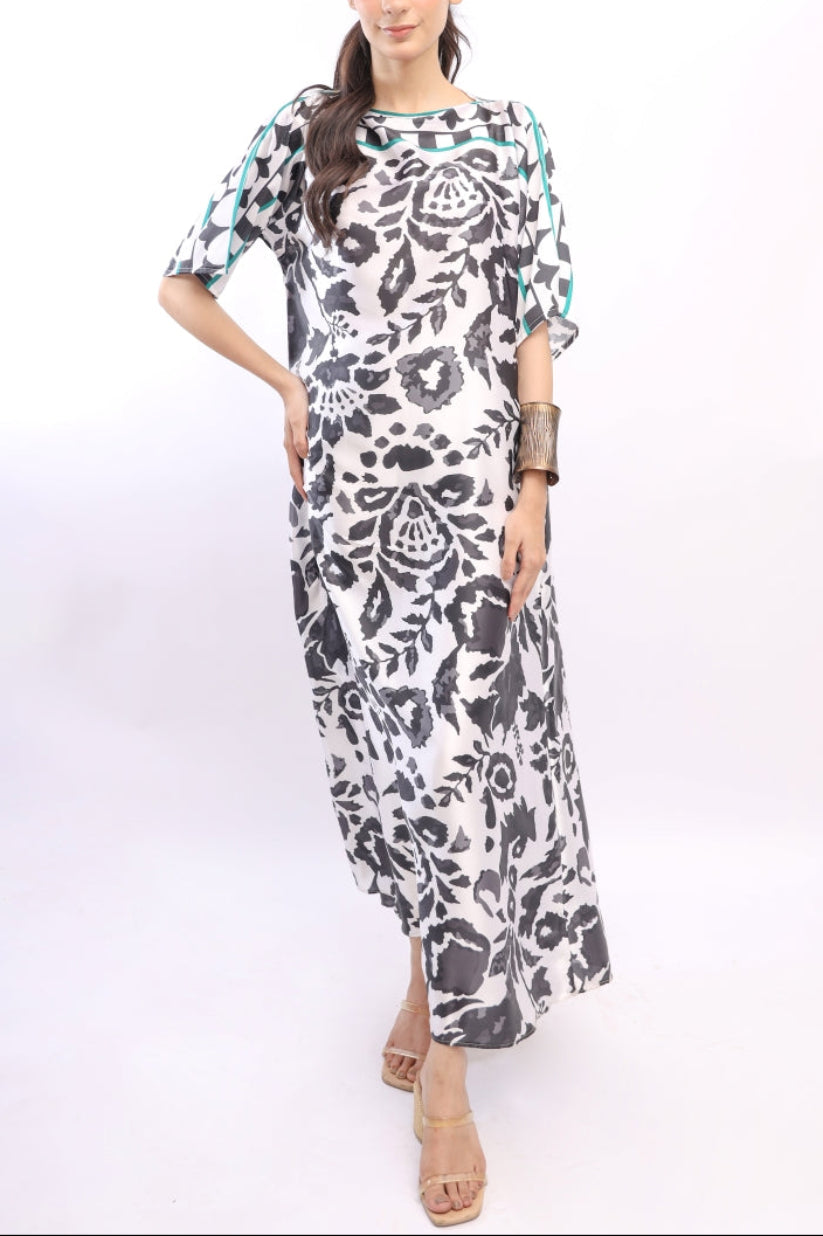 Woman wearing a black and white patterned dress on a white background