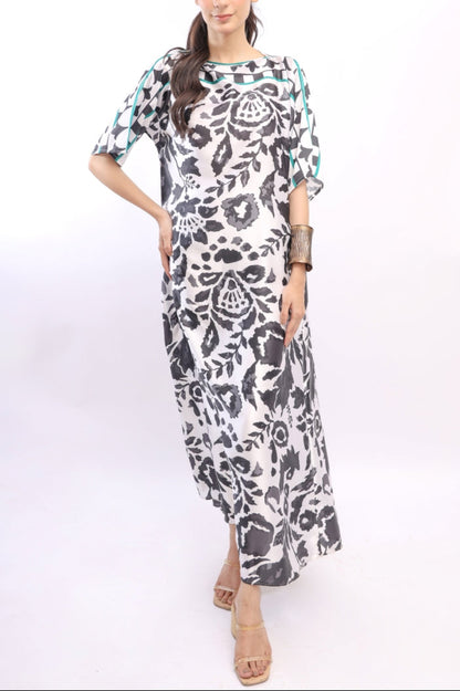 Woman wearing a black and white patterned dress on a white background