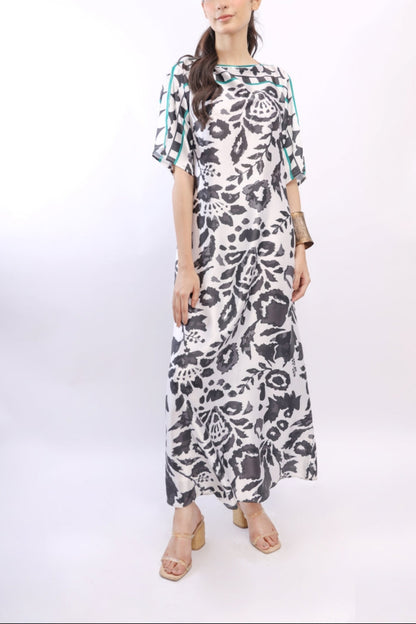 Woman wearing a floral patterned dress on a white background
