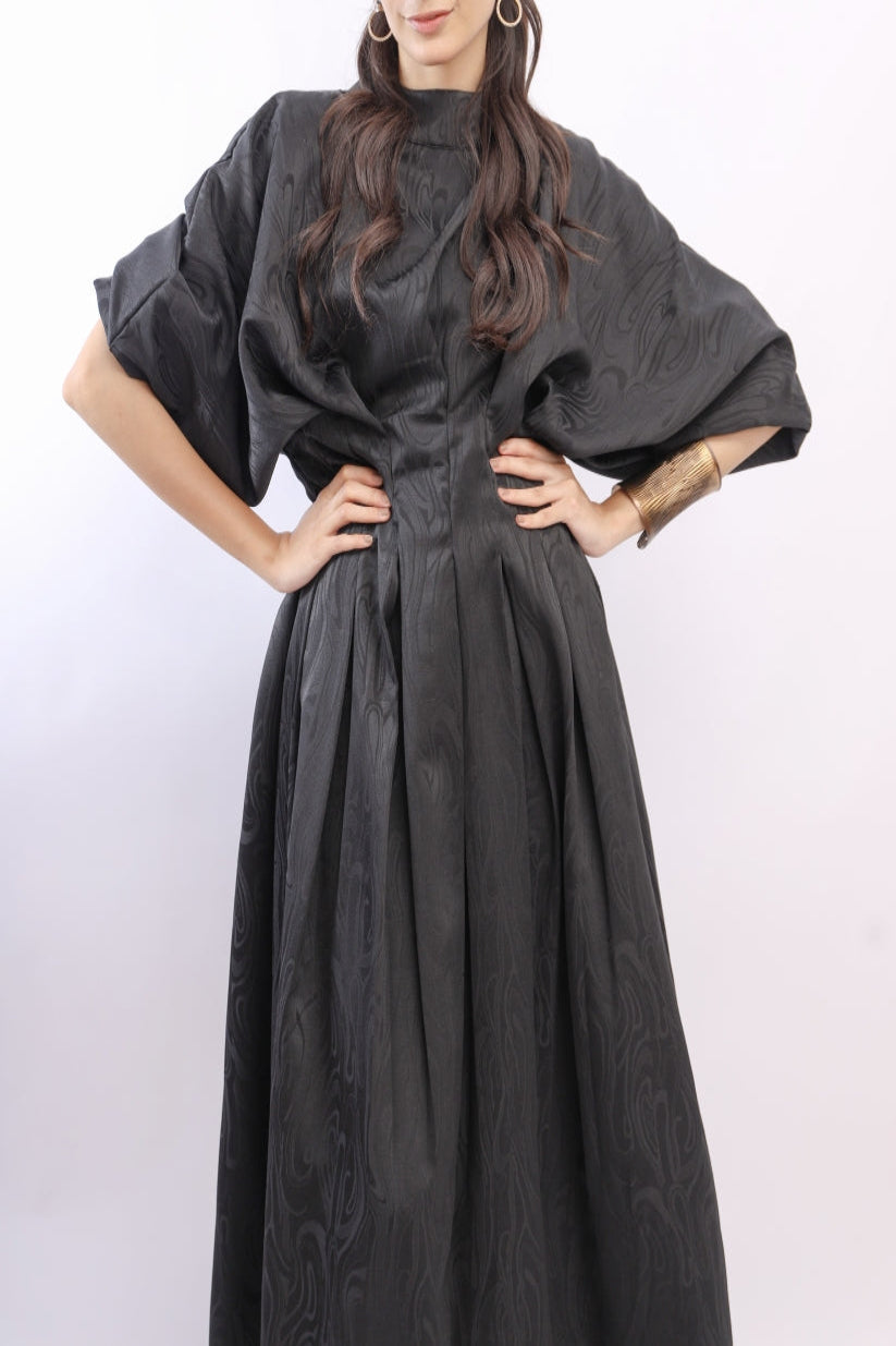 Woman wearing a black dress with a white background