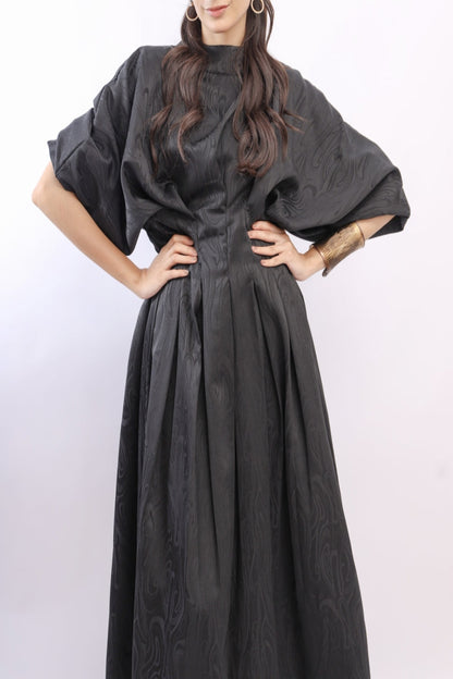 Woman wearing a black dress with a white background