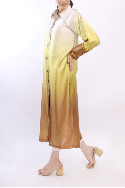 Woman wearing a long, light-colored dress with a gradient effect on a white background