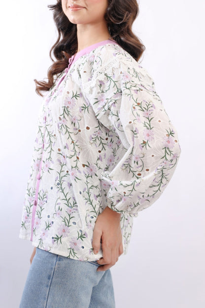 Woman wearing a floral blouse with a white background