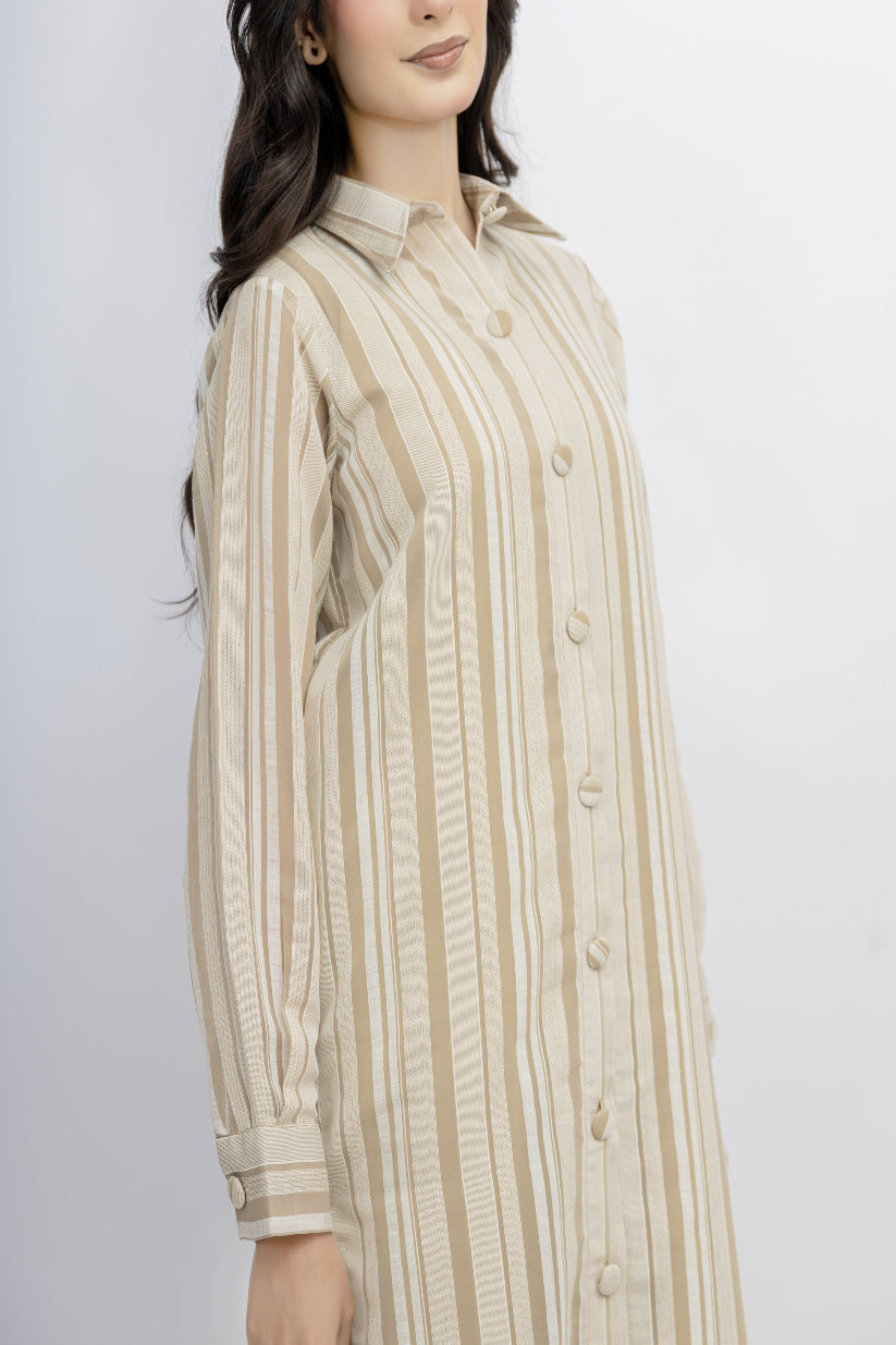 Woman wearing a beige and brown striped shirt against a white background