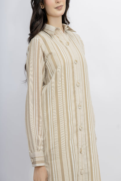 Woman wearing a beige and brown striped shirt against a white background