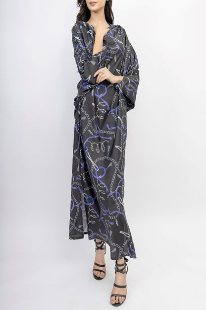 Woman wearing a black and purple patterned dress on a white background