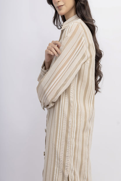 Woman wearing a beige and brown striped shirt against a white background