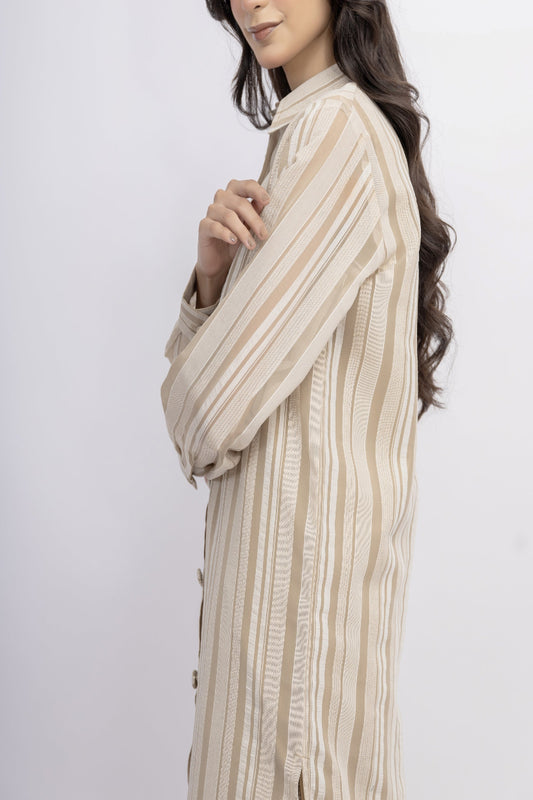 Woman wearing a beige and brown striped shirt against a white background